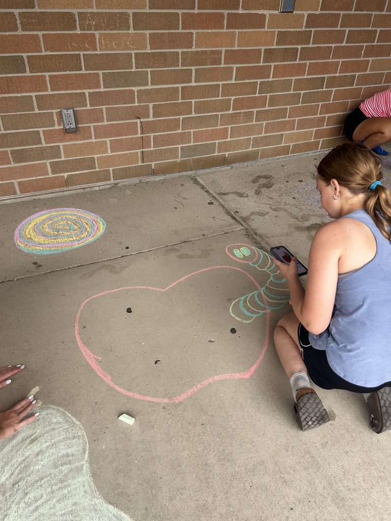 Riverdale Girls Highschool Soccer Team create chalk drawings at the student entrances to bring in the new school year with pride and fun.