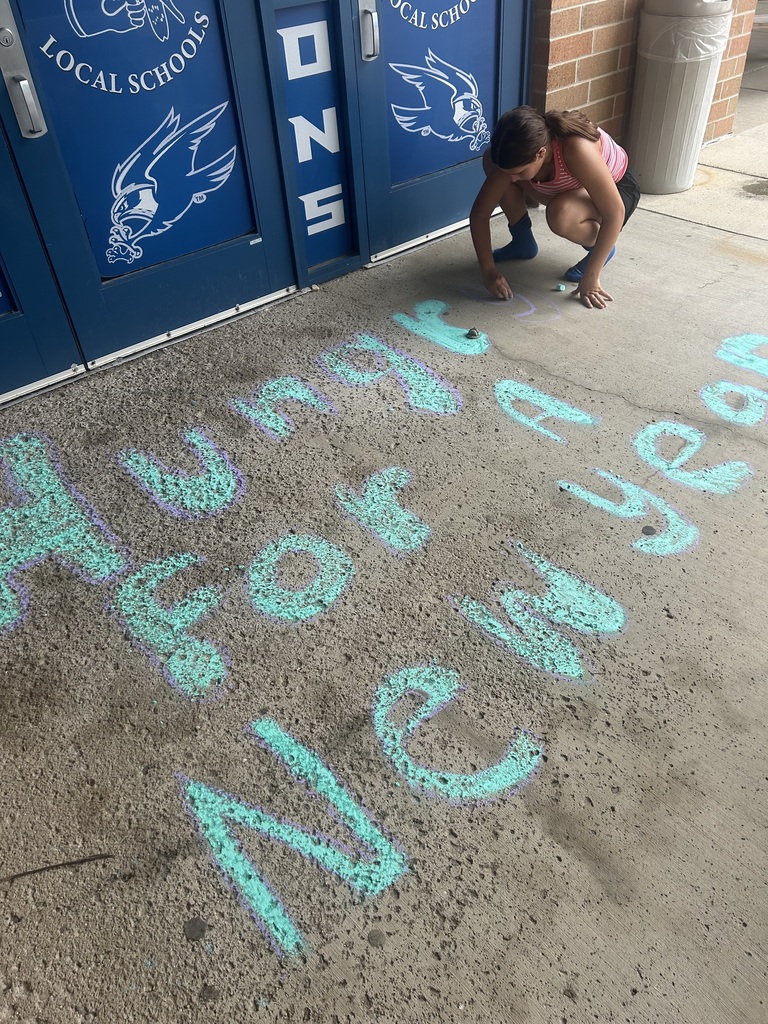 Riverdale Girls Highschool Soccer Team create chalk drawings at the student entrances to bring in the new school year with pride and fun.