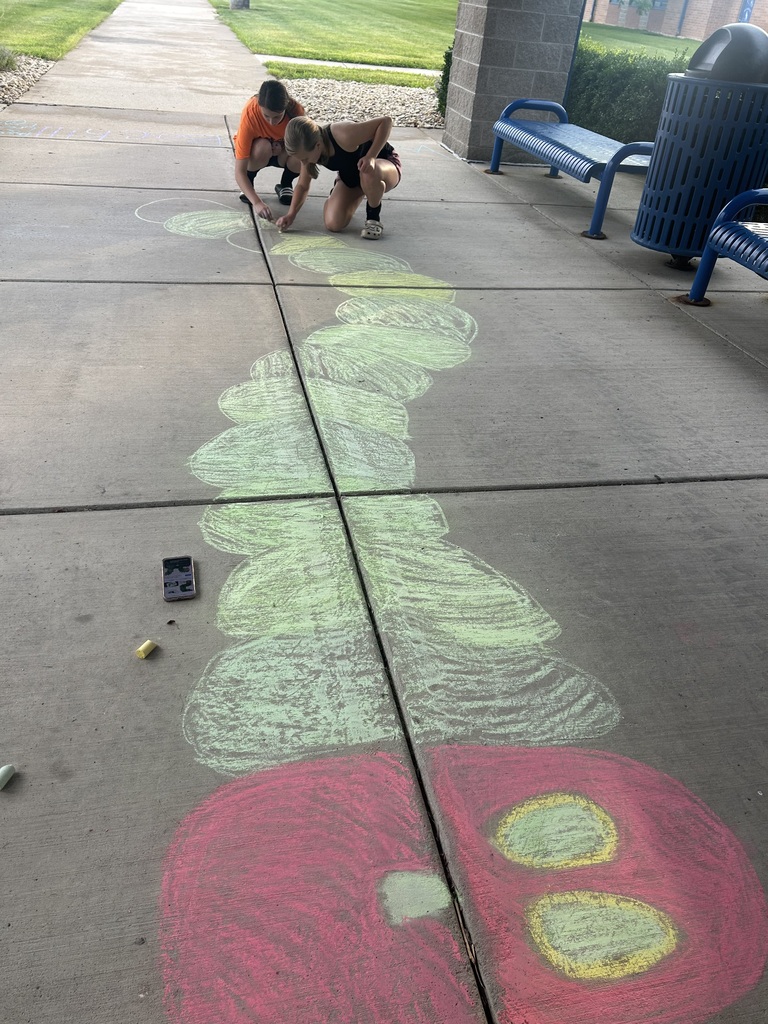 Riverdale Girls Highschool Soccer Team create chalk drawings at the student entrances to bring in the new school year with pride and fun.