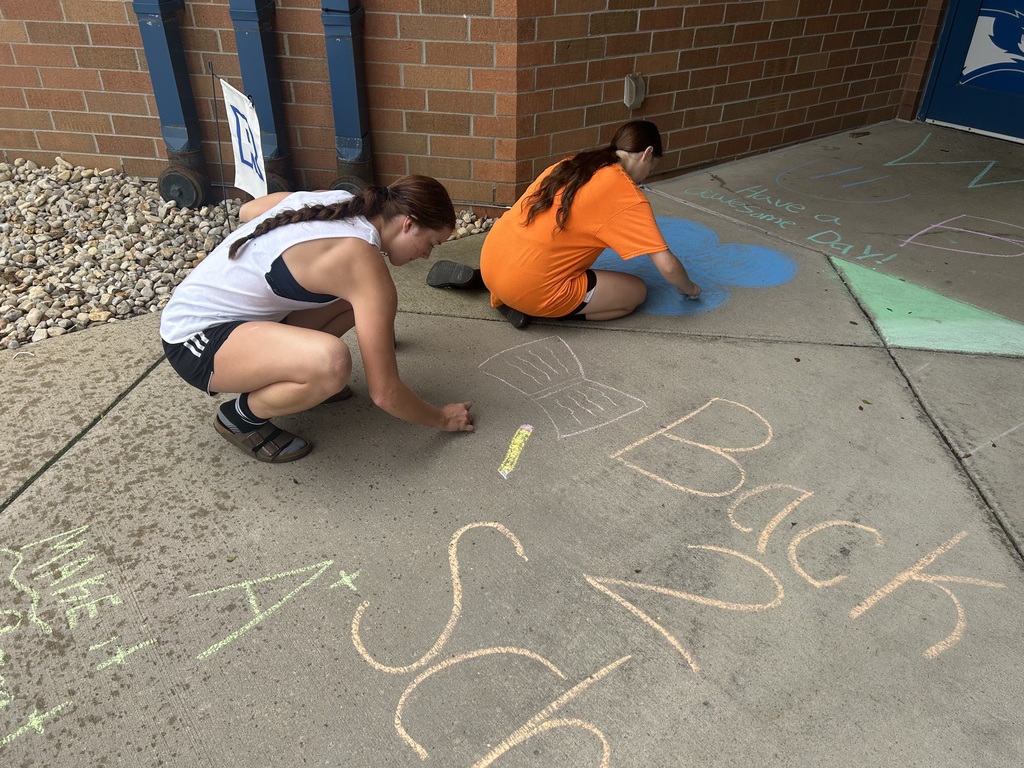 Riverdale Girls Highschool Soccer Team create chalk drawings at the student entrances to bring in the new school year with pride and fun.