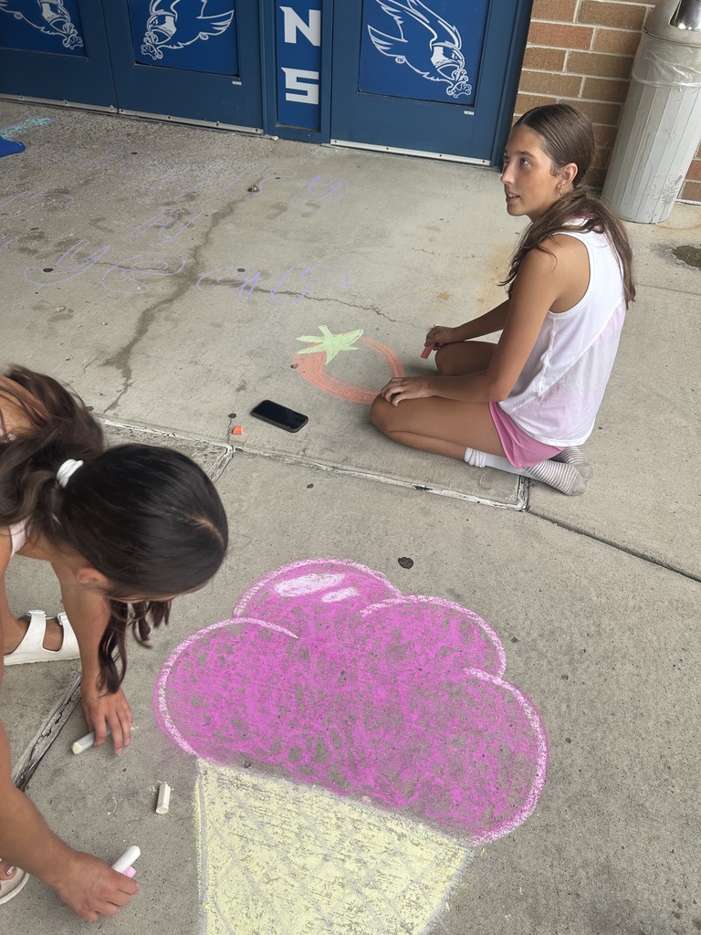 Riverdale Girls Highschool Soccer Team create chalk drawings at the student entrances to bring in the new school year with pride and fun.