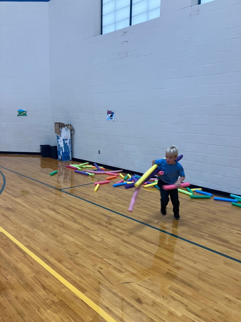 1st grade students in the gym collecting pool noodles