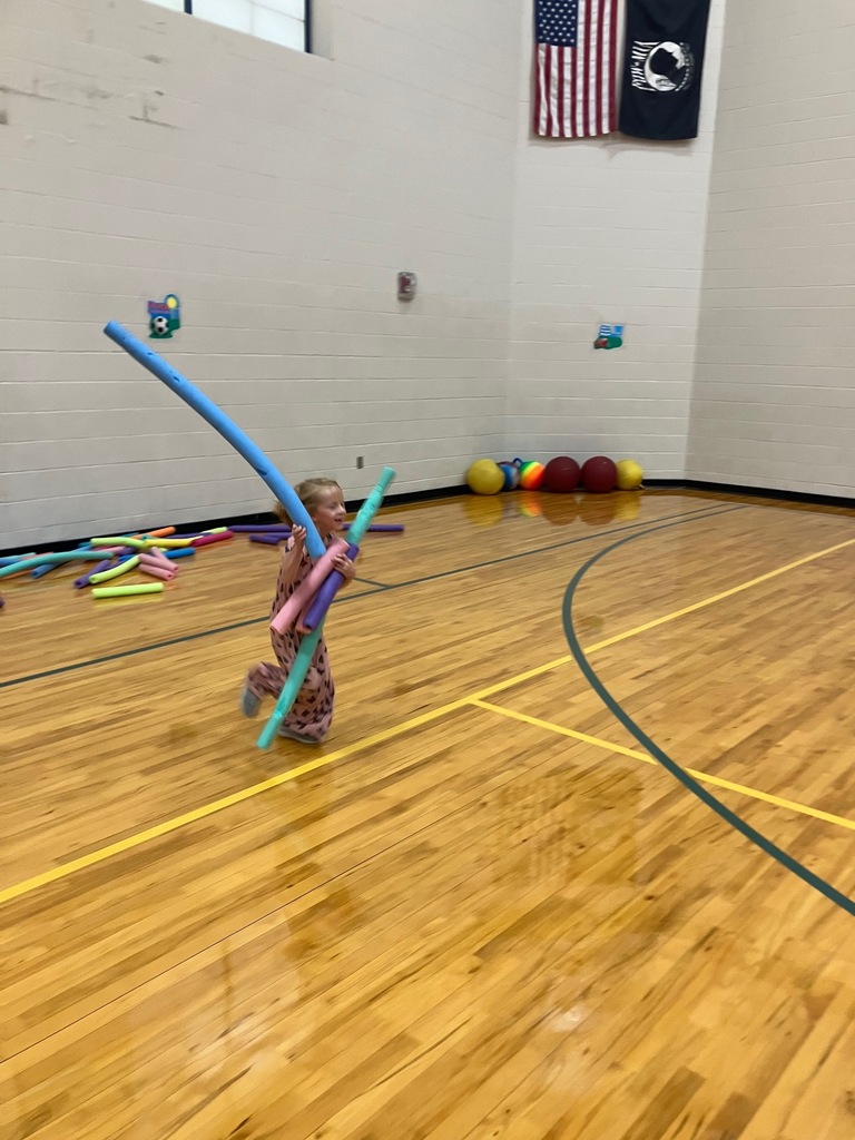 1st grade students in the gym collecting pool noodles