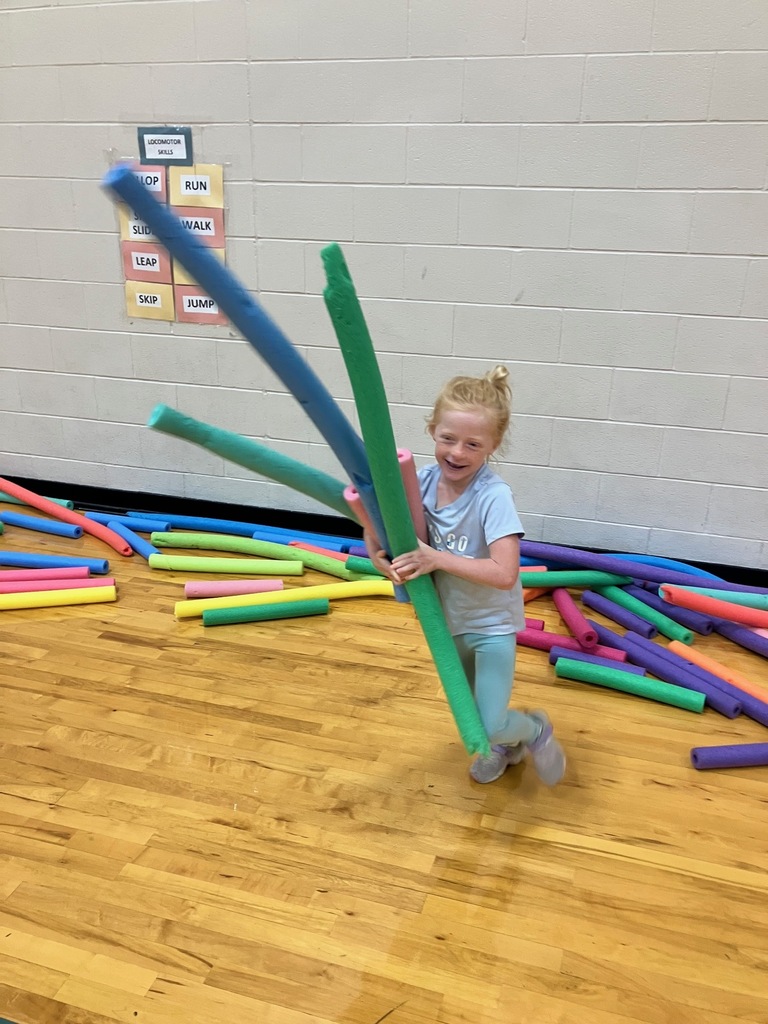 1st grade students in the gym collecting pool noodles