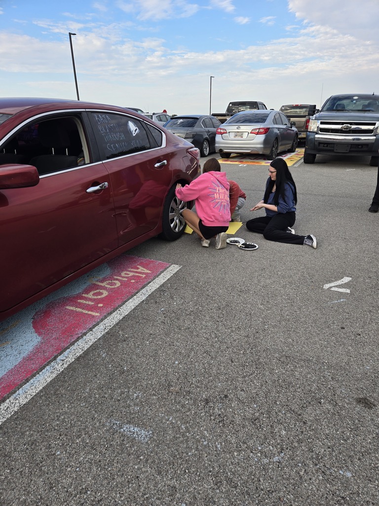 students making tire prints from their own cars