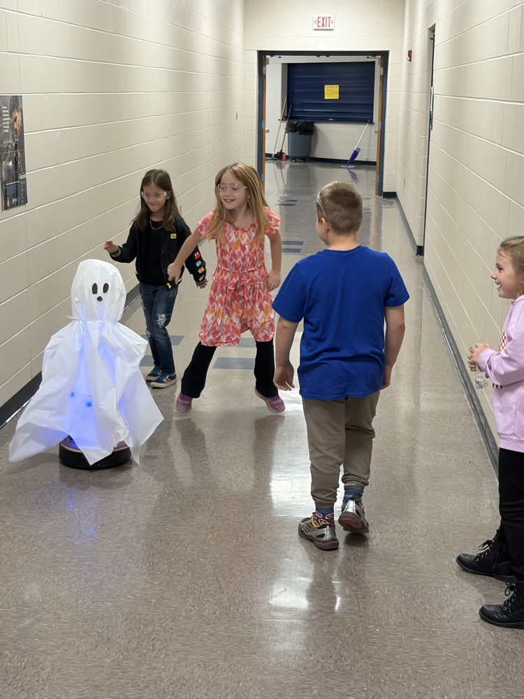 Elementary students helping HS robotics students build ROOMBA Halloween robots into ghosts/brooms/spiders