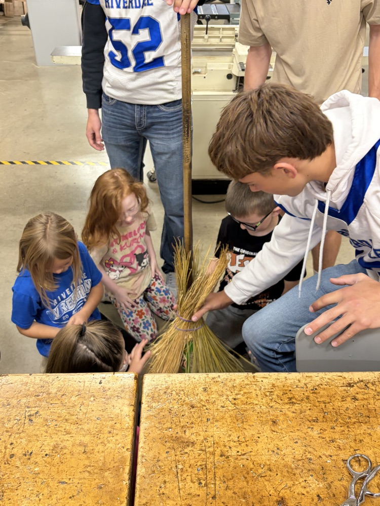 Elementary students helping HS robotics students build ROOMBA Halloween robots into ghosts/brooms/spiders