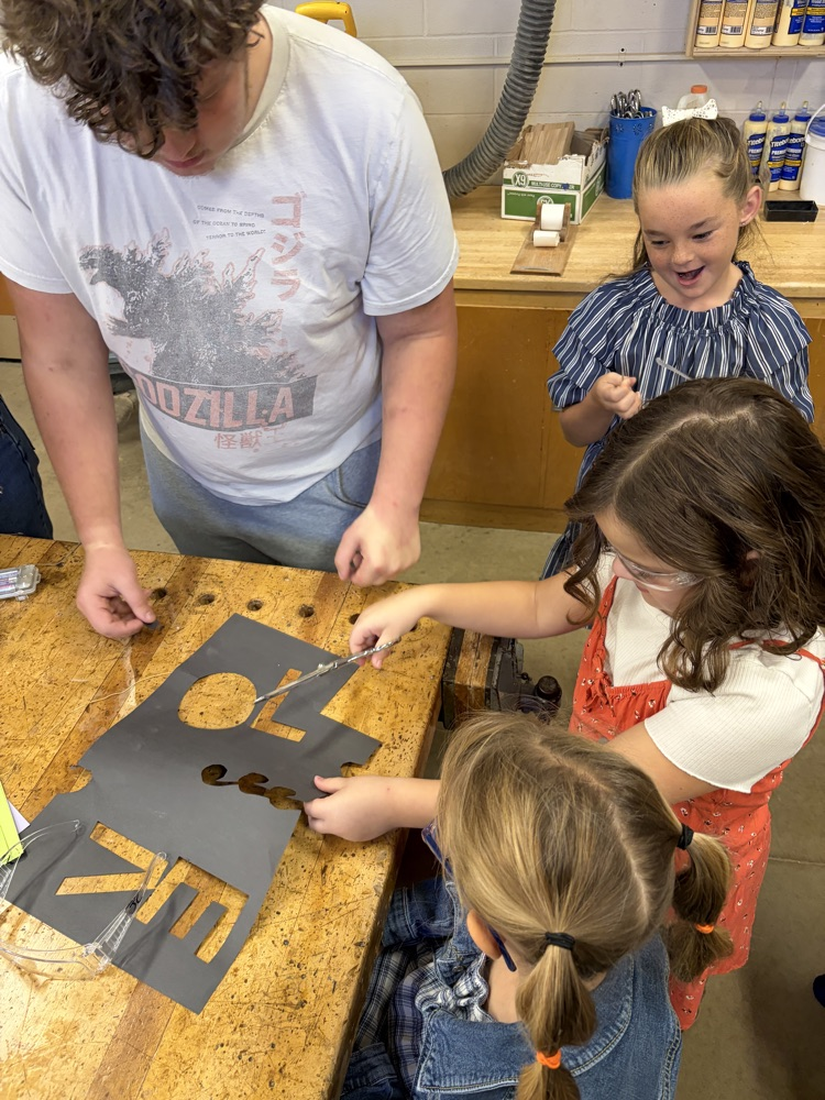 Elementary students helping HS robotics students build ROOMBA Halloween robots into ghosts/brooms/spiders