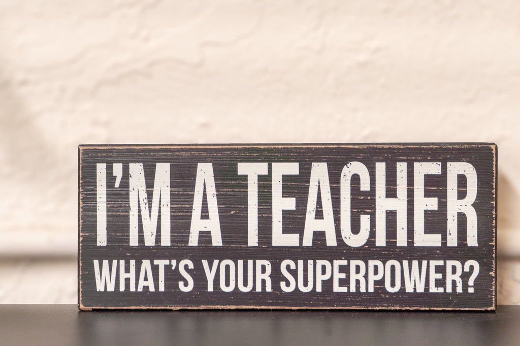A decorative sign reads, "I'm a teacher. What's your superpower?"