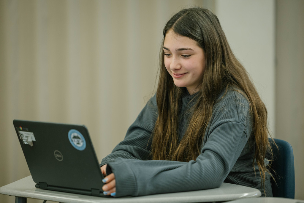 A female student works on a computer.