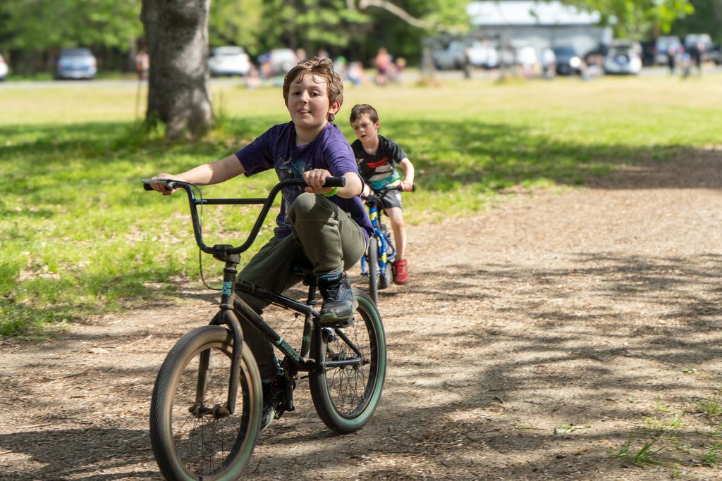 A boy rides a bike towards the camera.