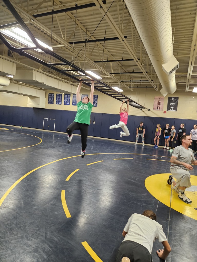 JH Wrestling girls practicing the monkey bars at the end of practice. 