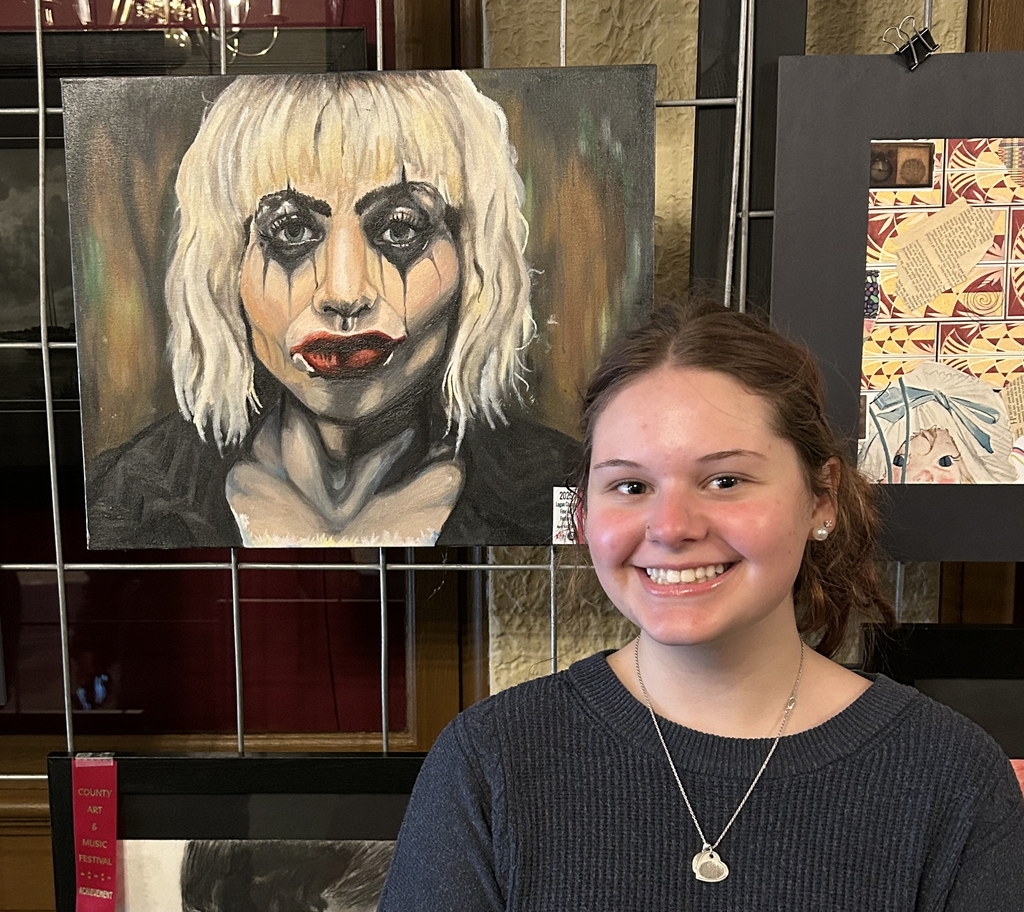 Allison Estep with her oil painting "Lady Gaga as Harley Quinn"