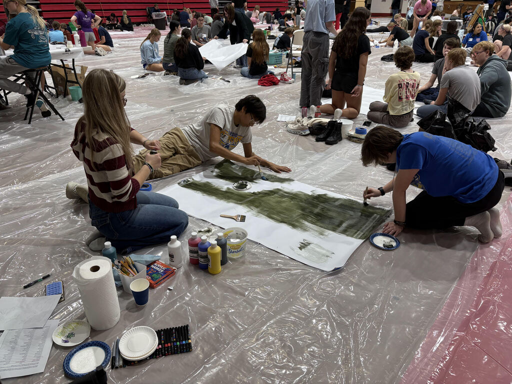 students beginning backdrop of mural
