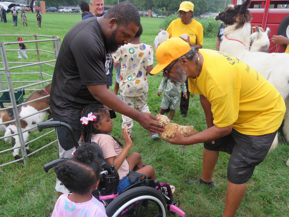 Child and parent petting animal