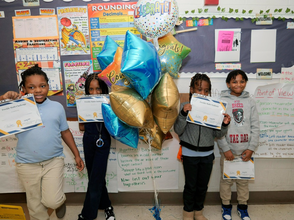 Students holding certificates for Freckle Math Challenge