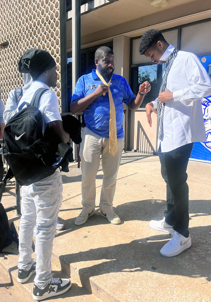 Dr. Smith showing students how to tie a necktie