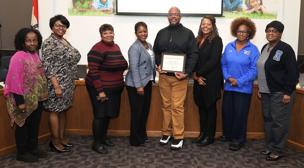 Johnathan Haynes receives the Riverview Excellence award from the Board of Education