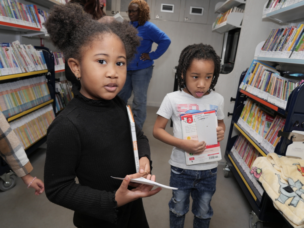 students in the mobile book van with slcl