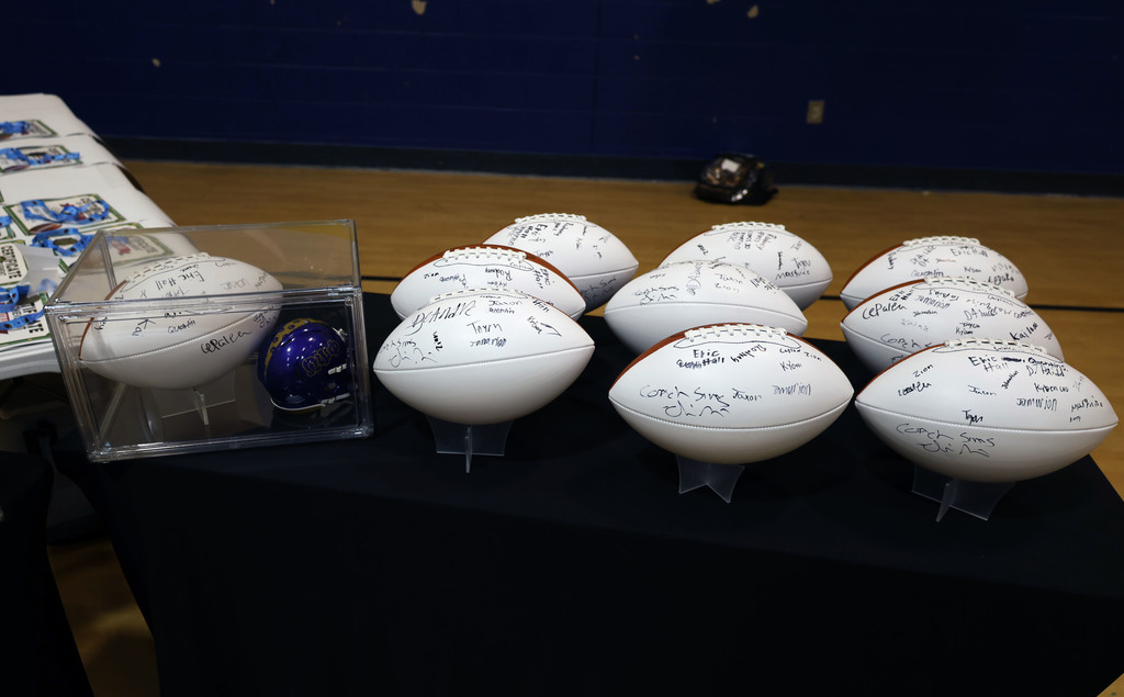 autographed footballs on table