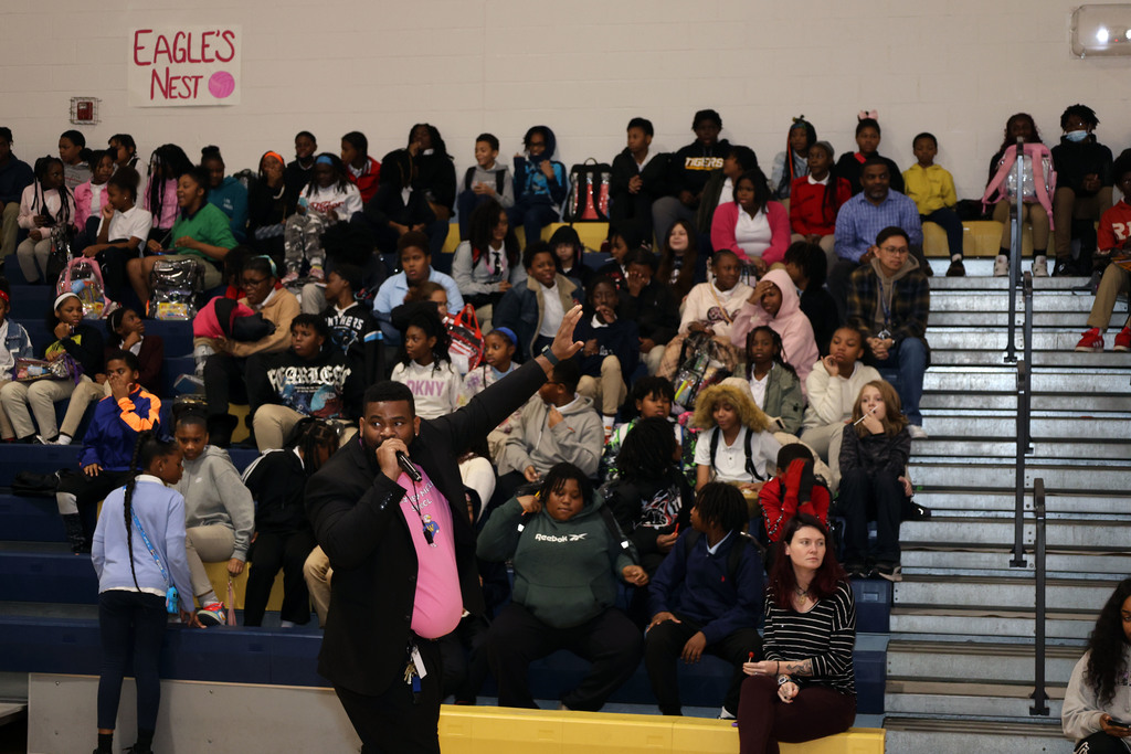 Dr. William Givens with hand raised while speaking to students