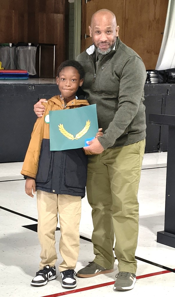 Danforth Elementary scholar Dejuan W. receives the Principal's Award.