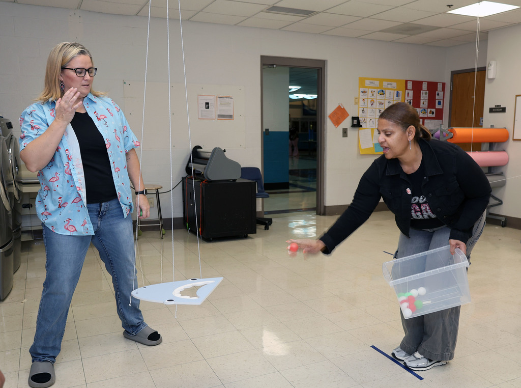 Woman tries to toss ping pong ball through shark mouth