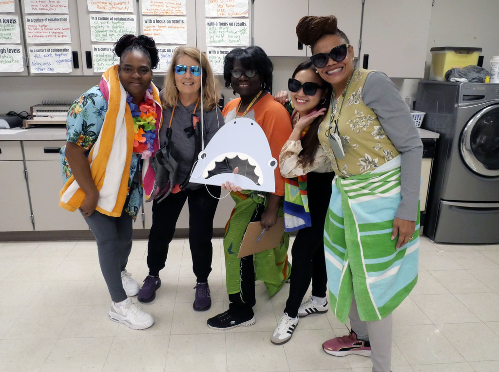 Team poses in front of shark