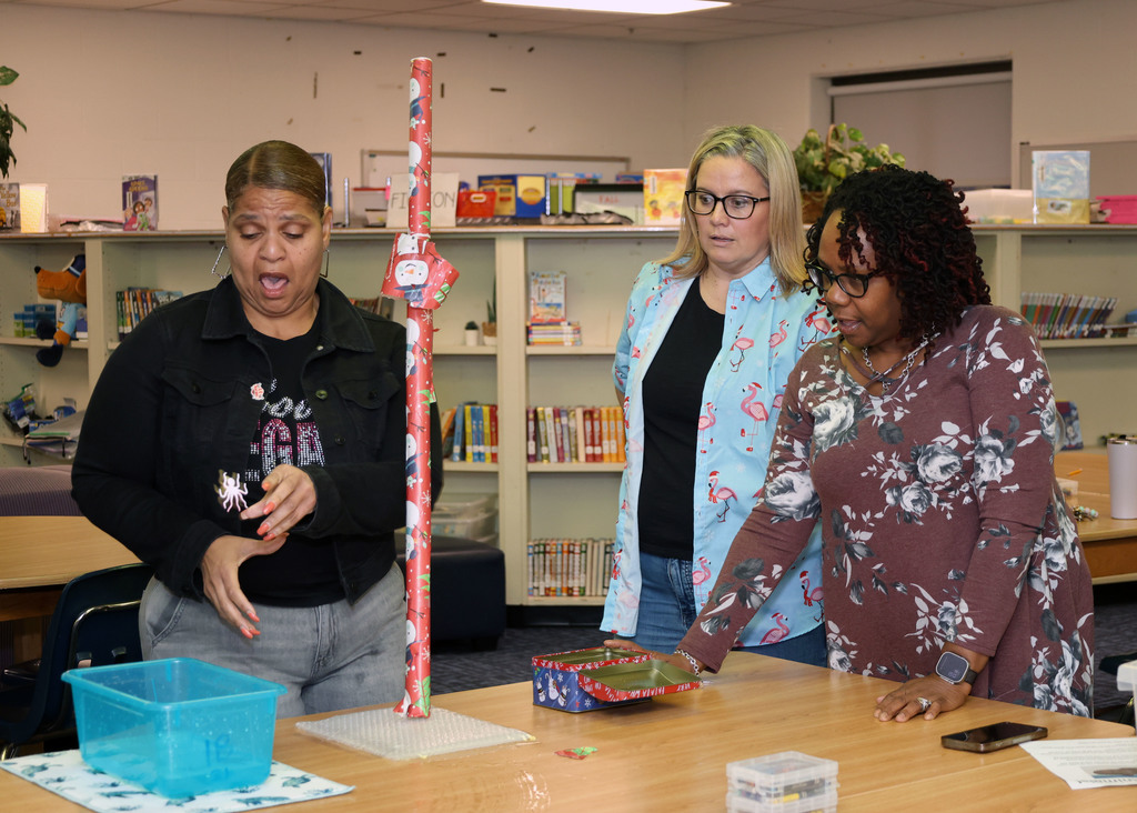 Woman balances wrapping paper while others look on