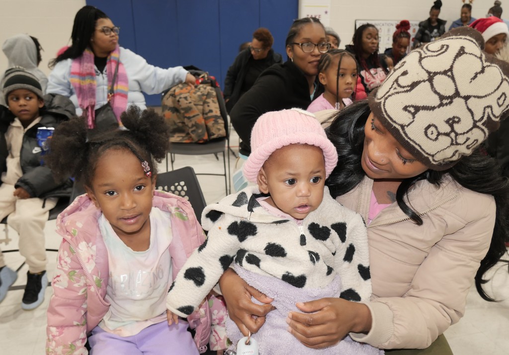 Mom and kids in crowd.