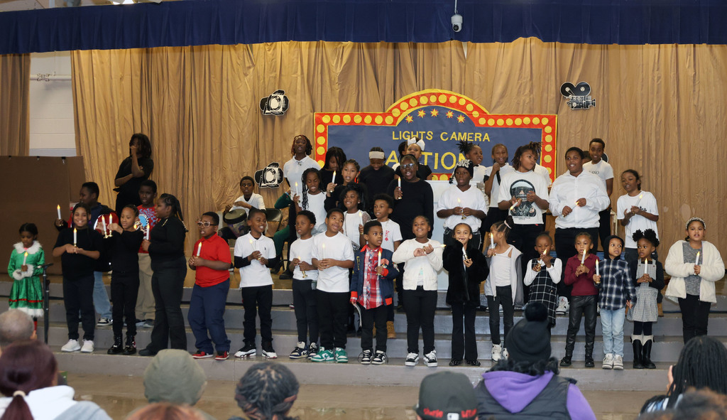 Students singing and holding candles