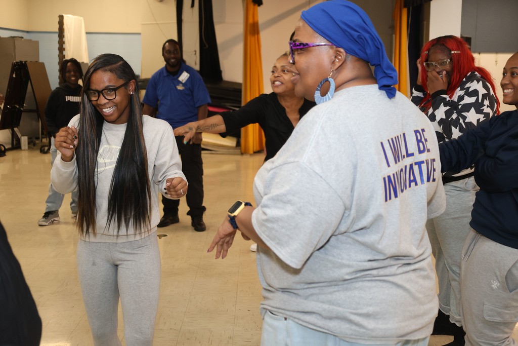 Participants laugh during improv comedy workshop