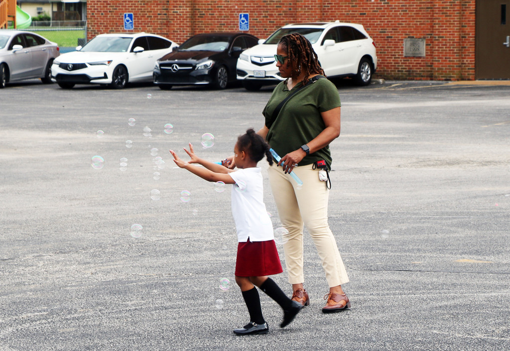 Kindergarten Roundup student playing with bubbles