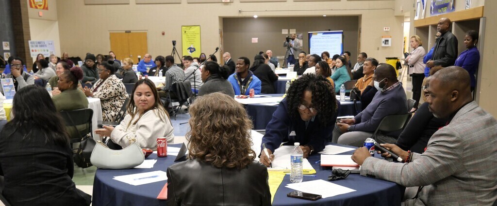 DESE Public Hearing attendees talk at table