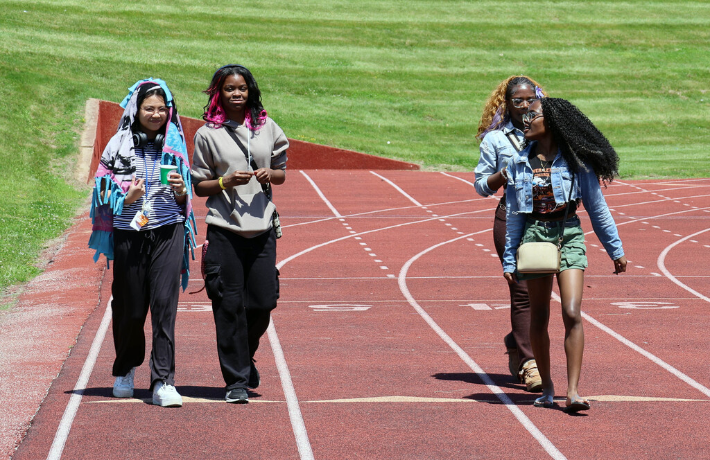 Four female RGHS students walk on the school track