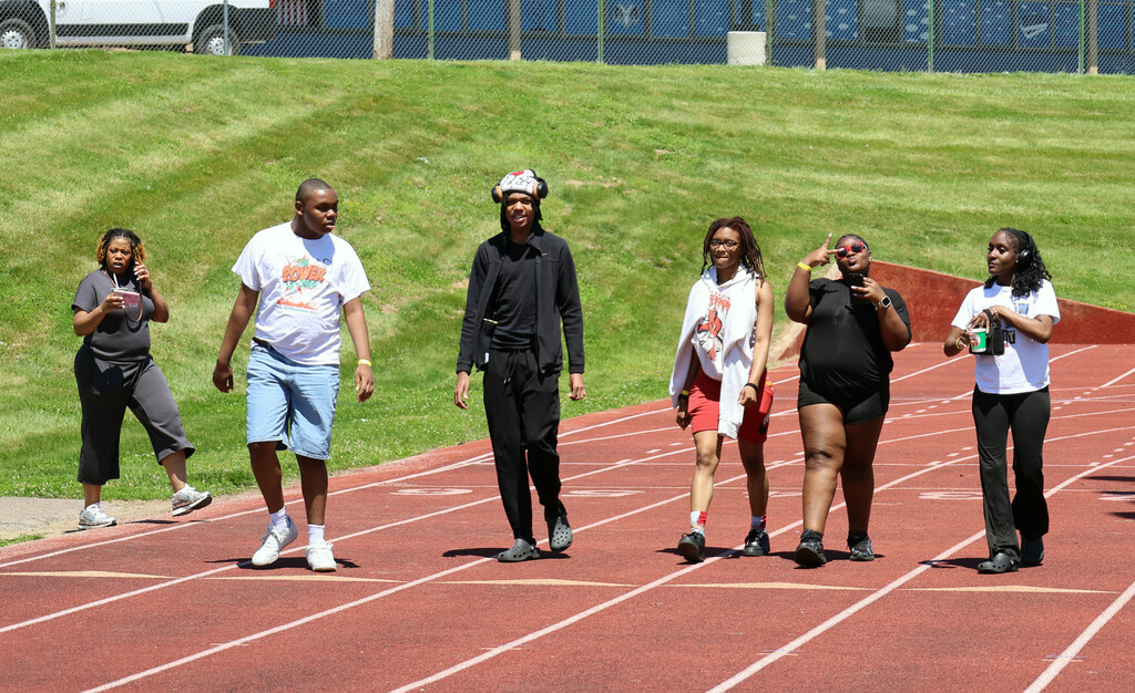 Several students walk on RGHS track