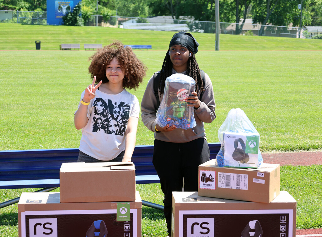A girl and boy students post with their prizes at RGHS field day