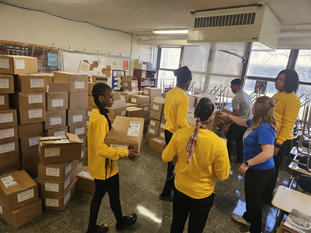 RGHS students carrying boxes and organizing room