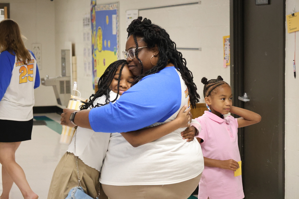 student hugging teacher