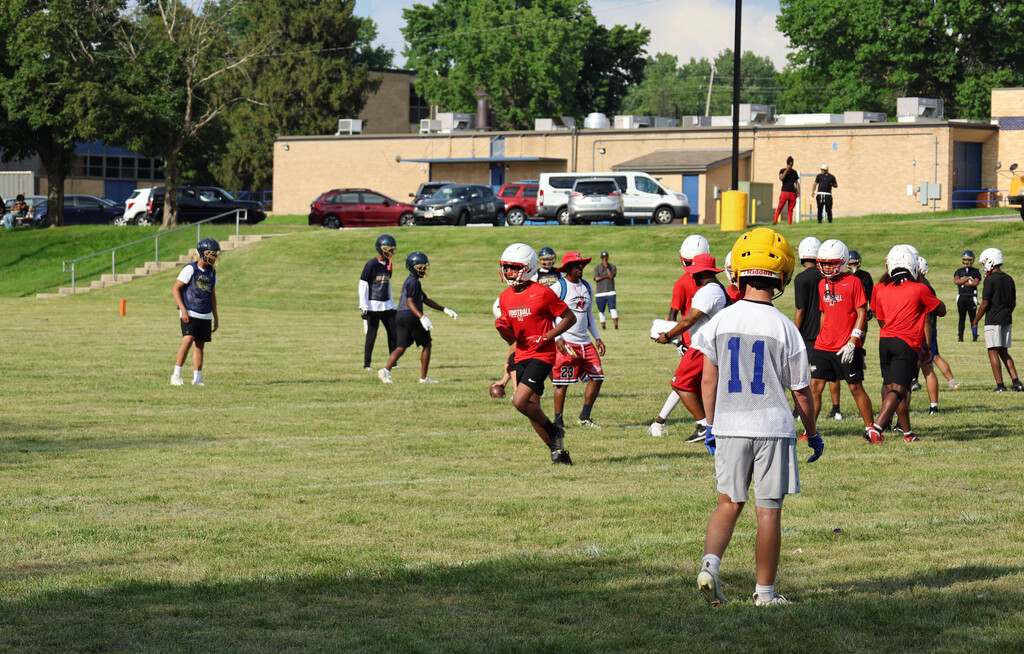 football players prepare to run a play on the field