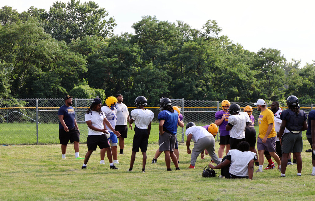 football players listen to advice from coaches