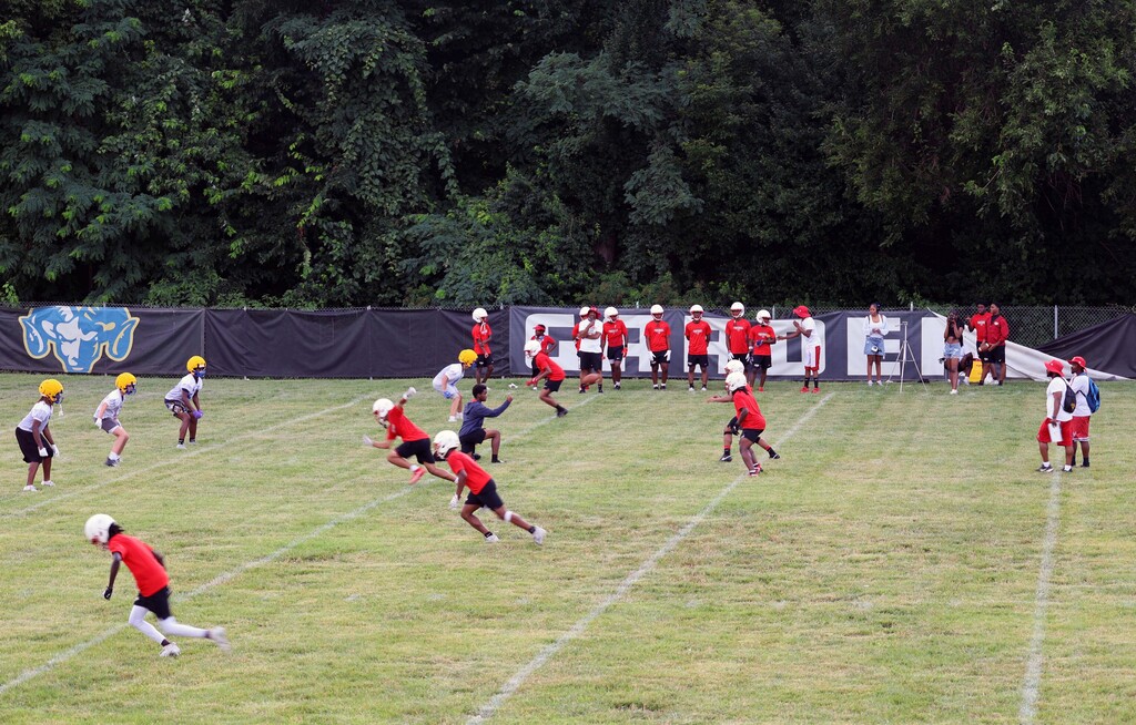 football players running a drill on the field