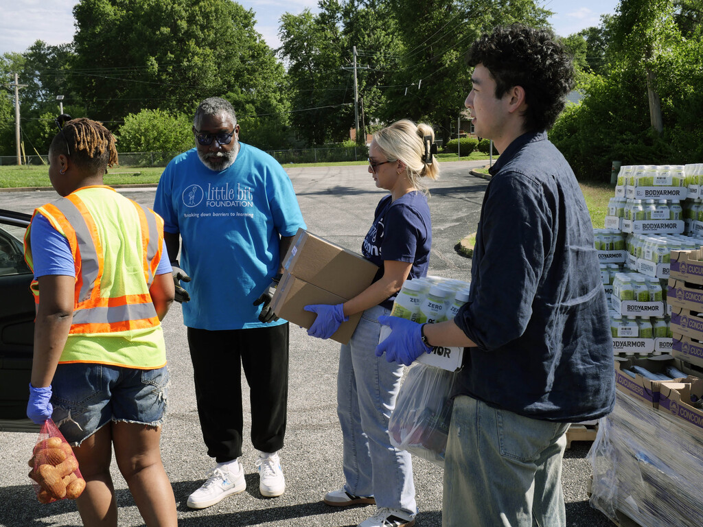 Volunteers distribute food those those in need