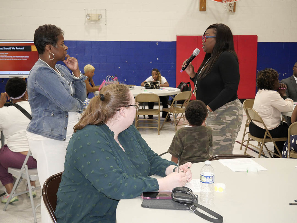 People speaking at community meeting