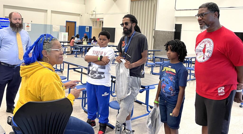 Family talking to Central Middle School staff members