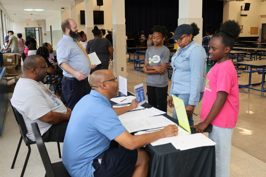 Family talking to CMS staff members