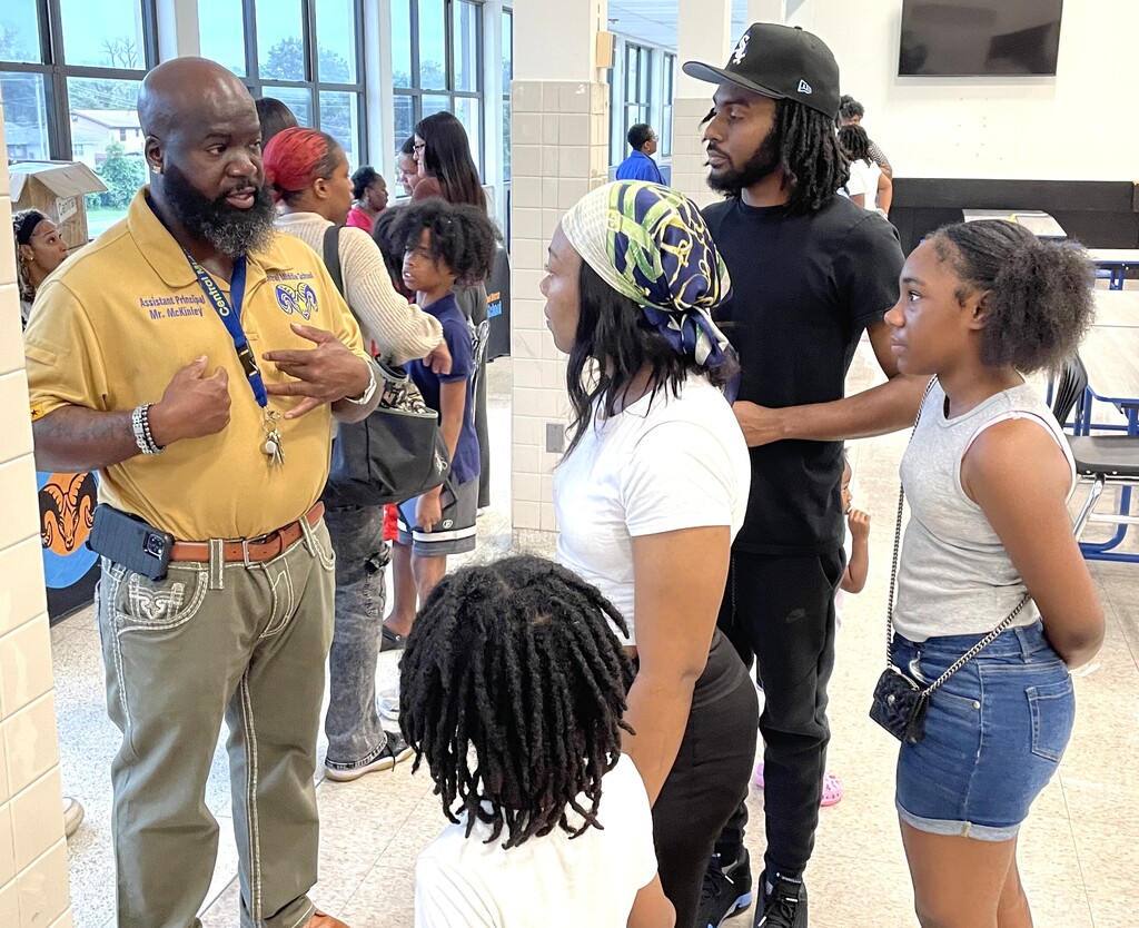 Family talking to school administrator