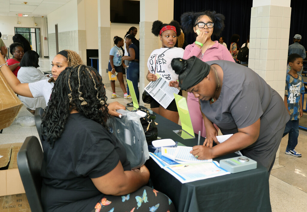Parent filling out paperwork at table