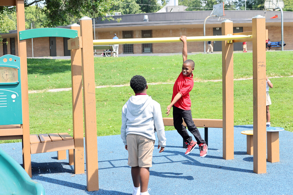 Koch student playing on monkey bars