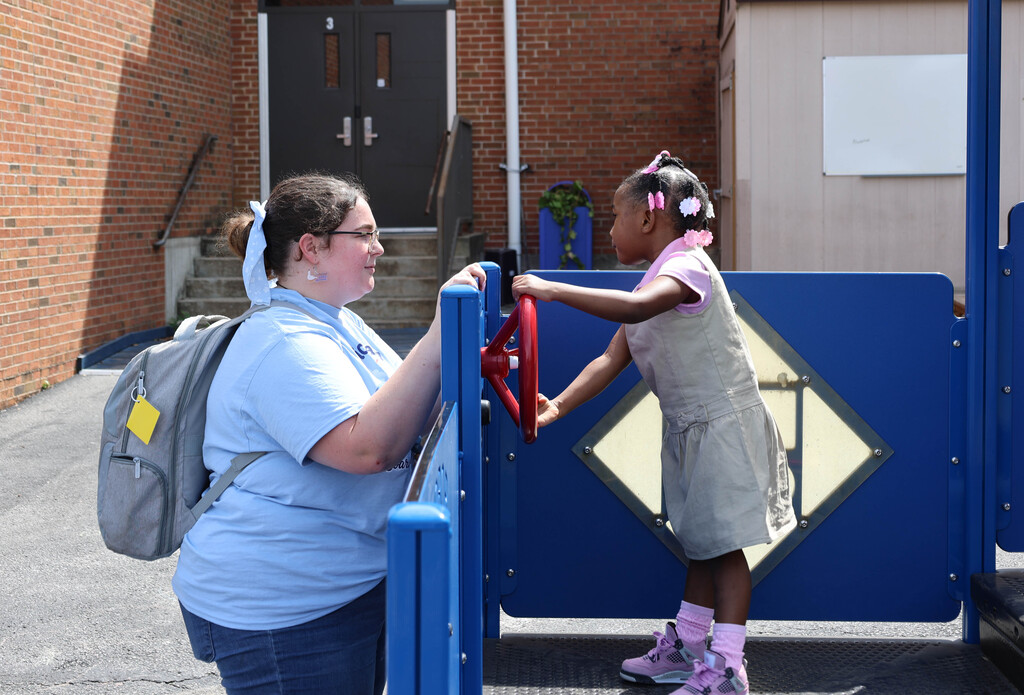 Girl playing with steering wheel on playground